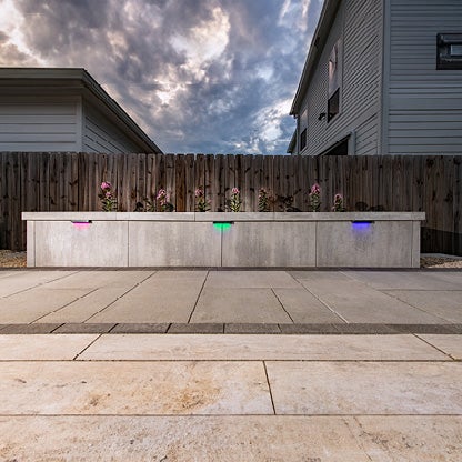 Outdoor walkway featuring multi-color accent lighting. 