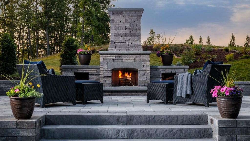 outdoor fireplace with wood storage paver patio seating area